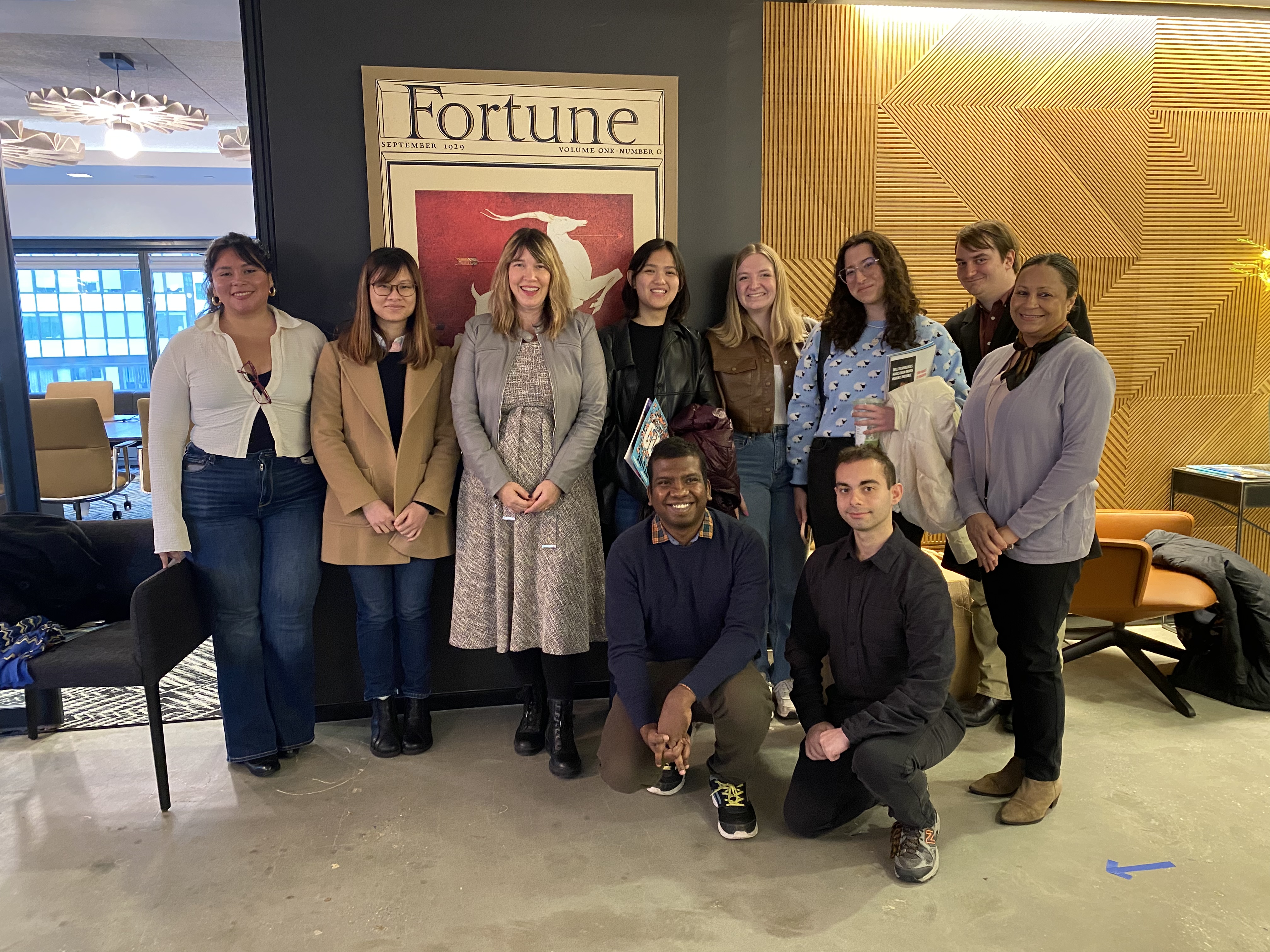 The students post with Megan Gilbert at Fortune Media