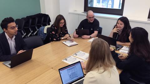 Students discussing around table