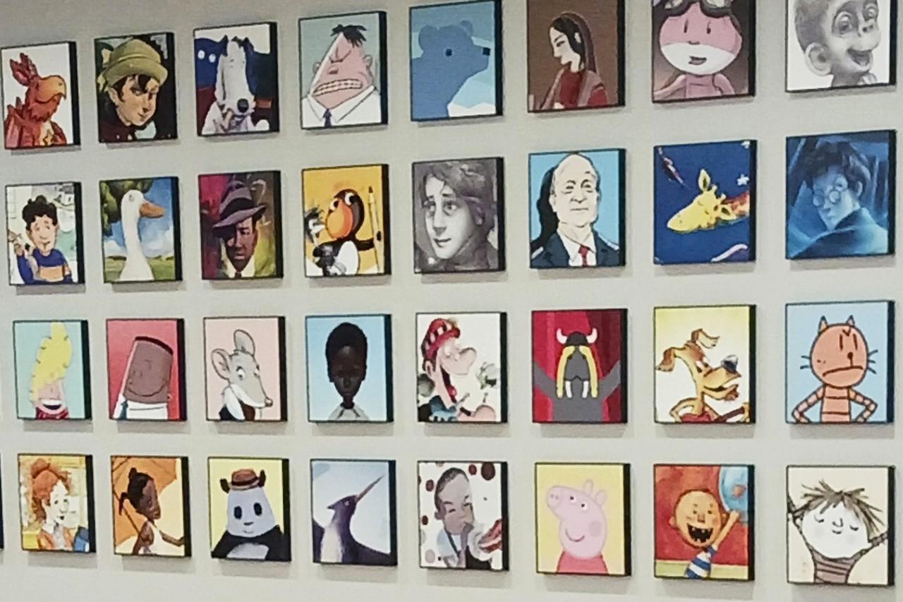 On a wall inside the Scholastic offices in NYC, a wall is full of squares of photos of book characters in rows