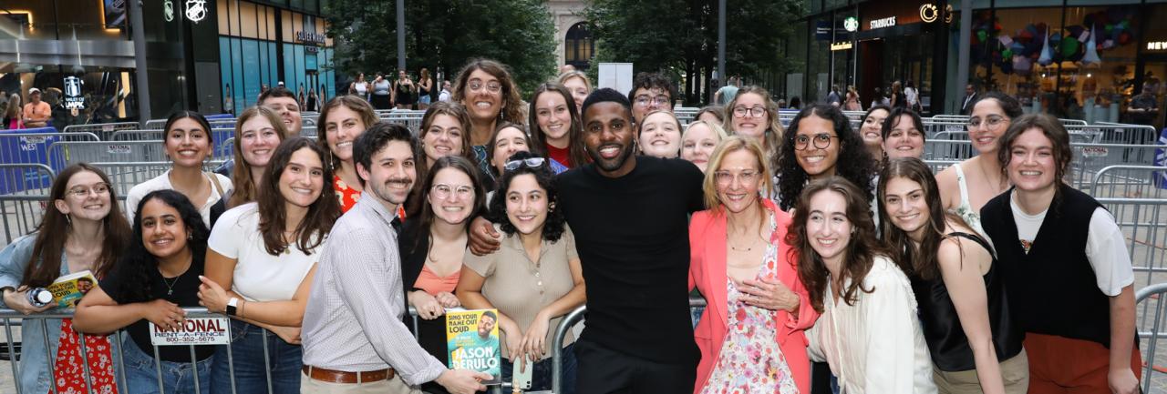 NYU SPS students stand in a crowd and pose with Jason Derulo