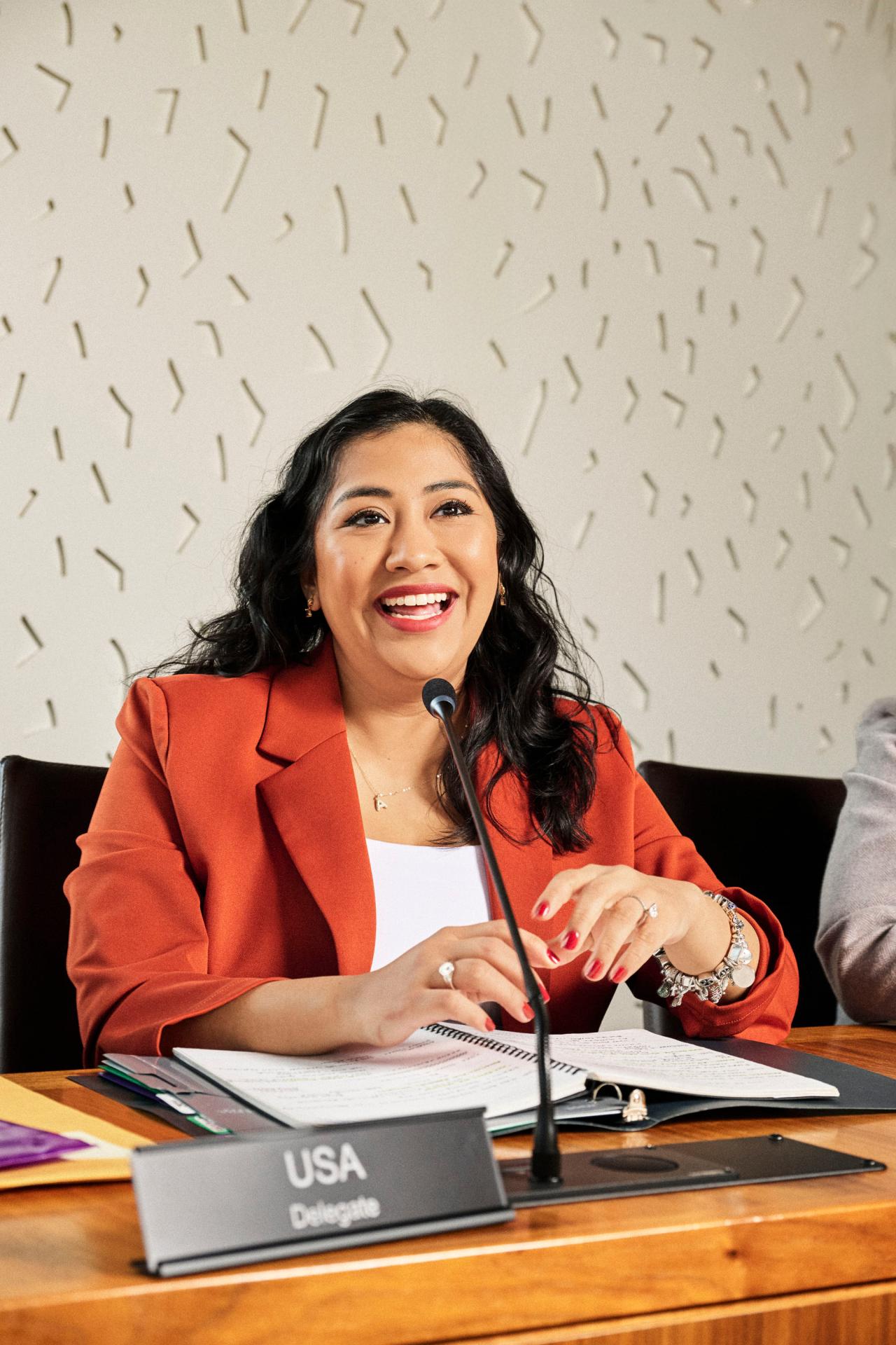 April speaking while sitting on a panel 
