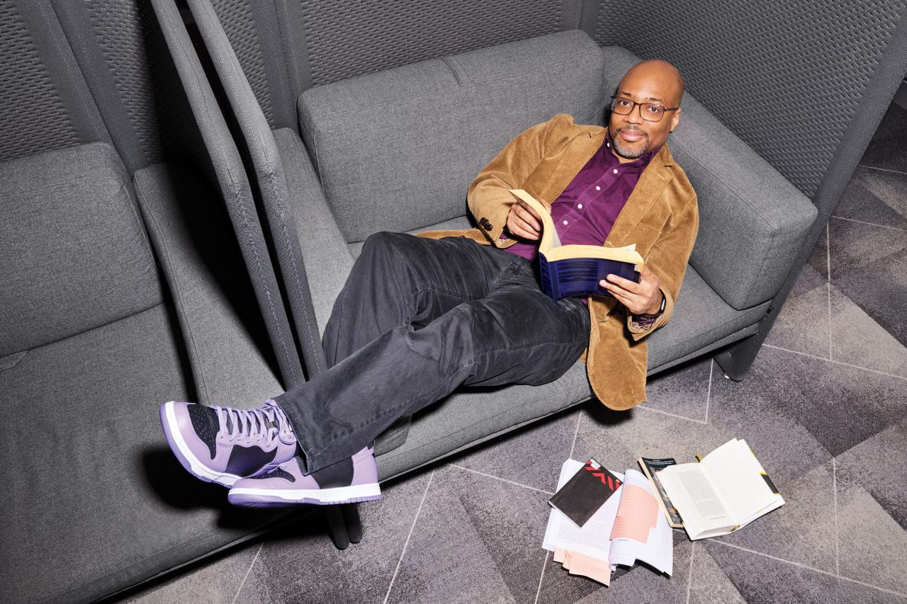 Jermaine lying on couch with a book