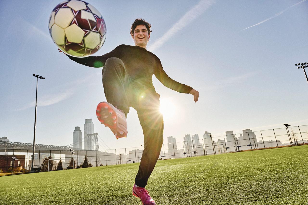 Loris kicking a soccer ball in a open field