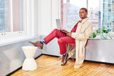 Soji sitting with a laptop.