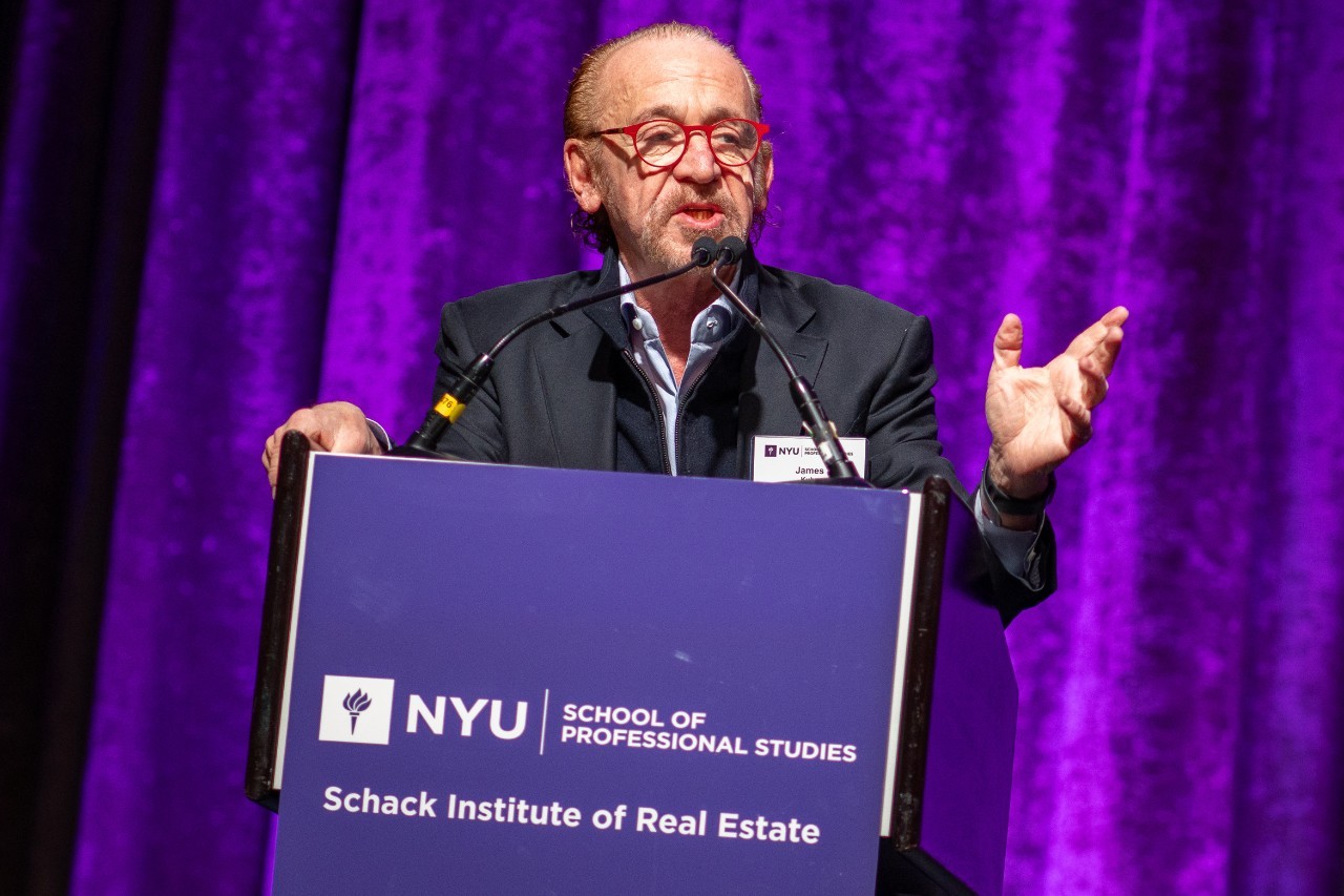James Kuhn speaks at a lectern at the Capital Markets in Real Estate Conference at NYU SPS.