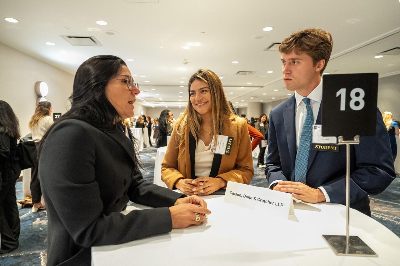 People gathering at a desk at a job fair