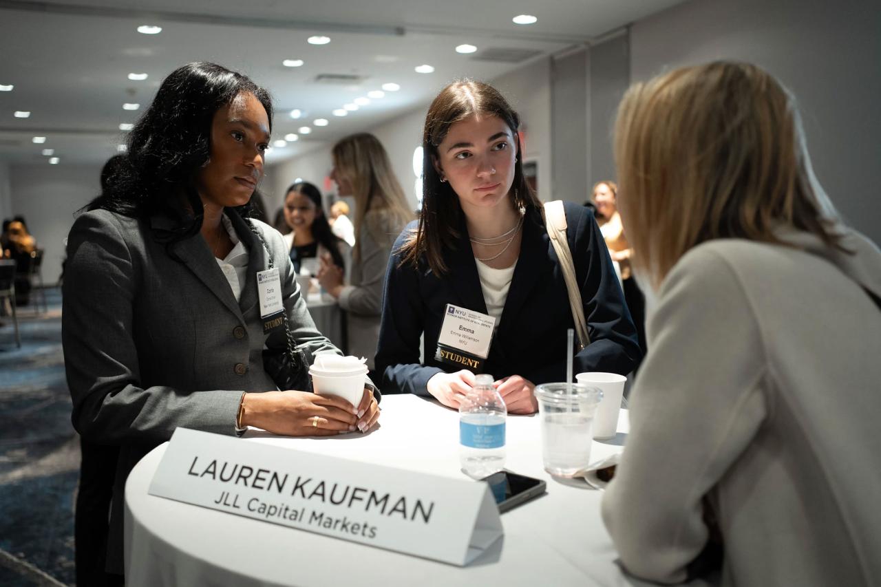 People gathering at a desk at a job fair