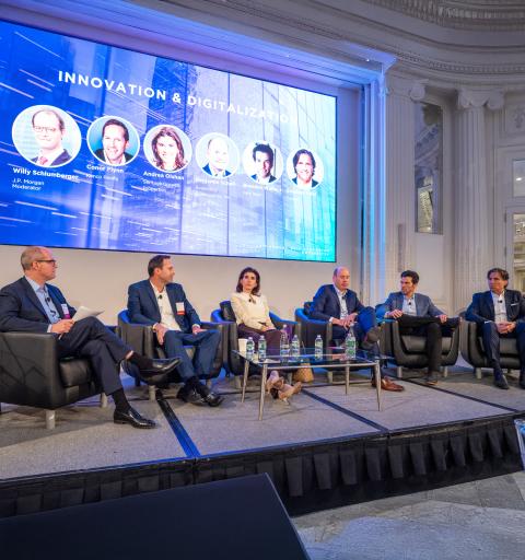 Panel sits on stage having a discussion.