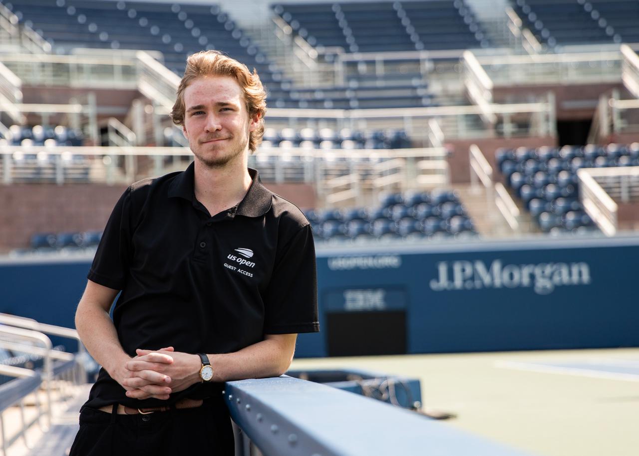 A man stands in a stadium.