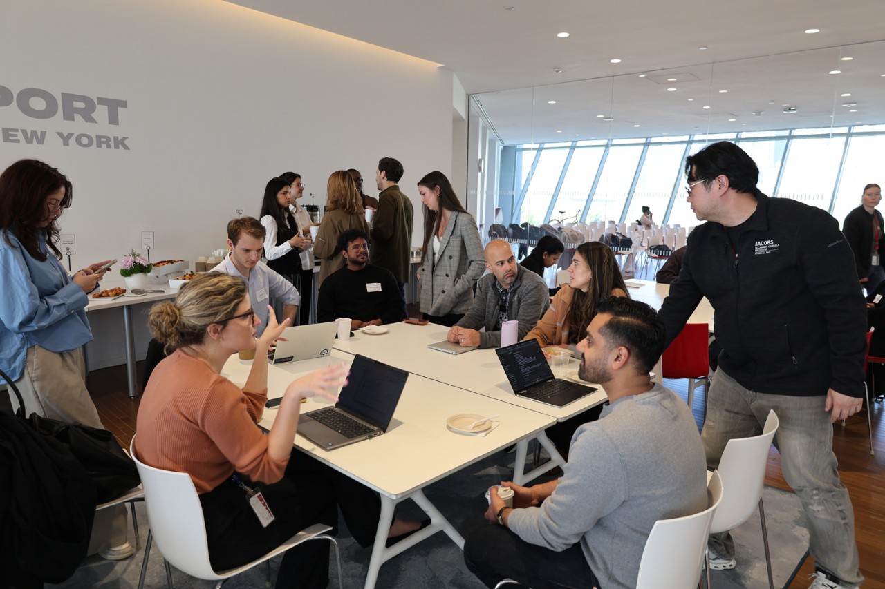CGA Fellowship participants collaborate around a large classroom table.