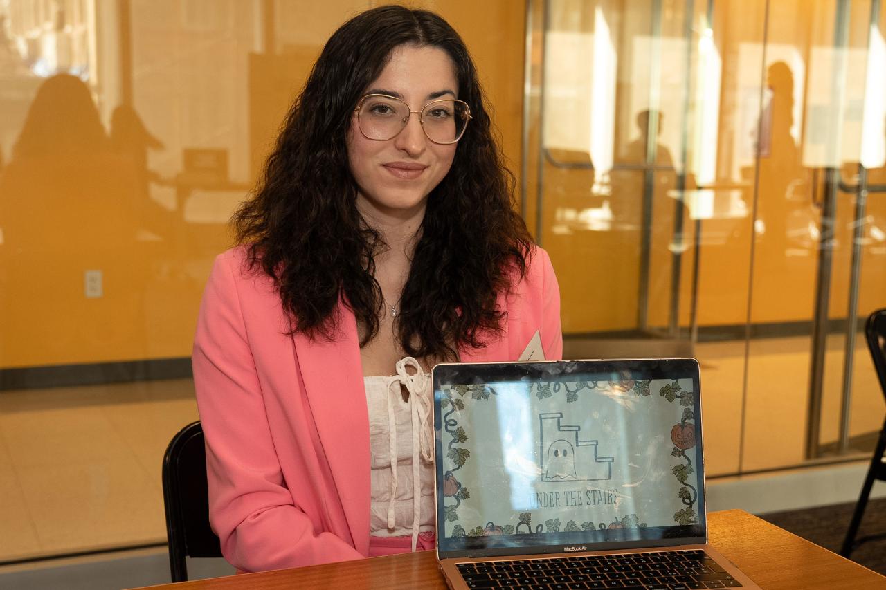 MS in Publishing grad Giorgi Rifaldi sits in front of a laptop.