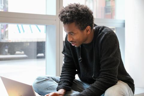 Student applying online on laptop