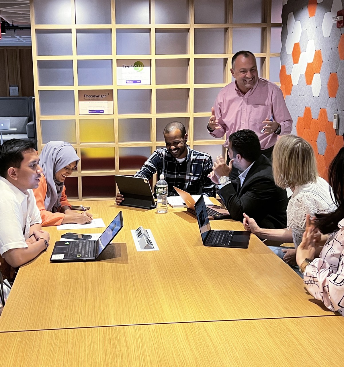 Students discuss their cohort presentations with their instructor