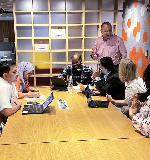 Students discuss their cohort presentations with their instructor