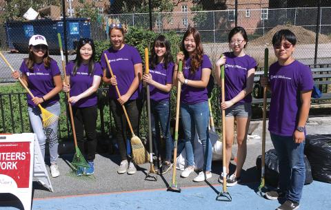Students hold shovels outdoors.