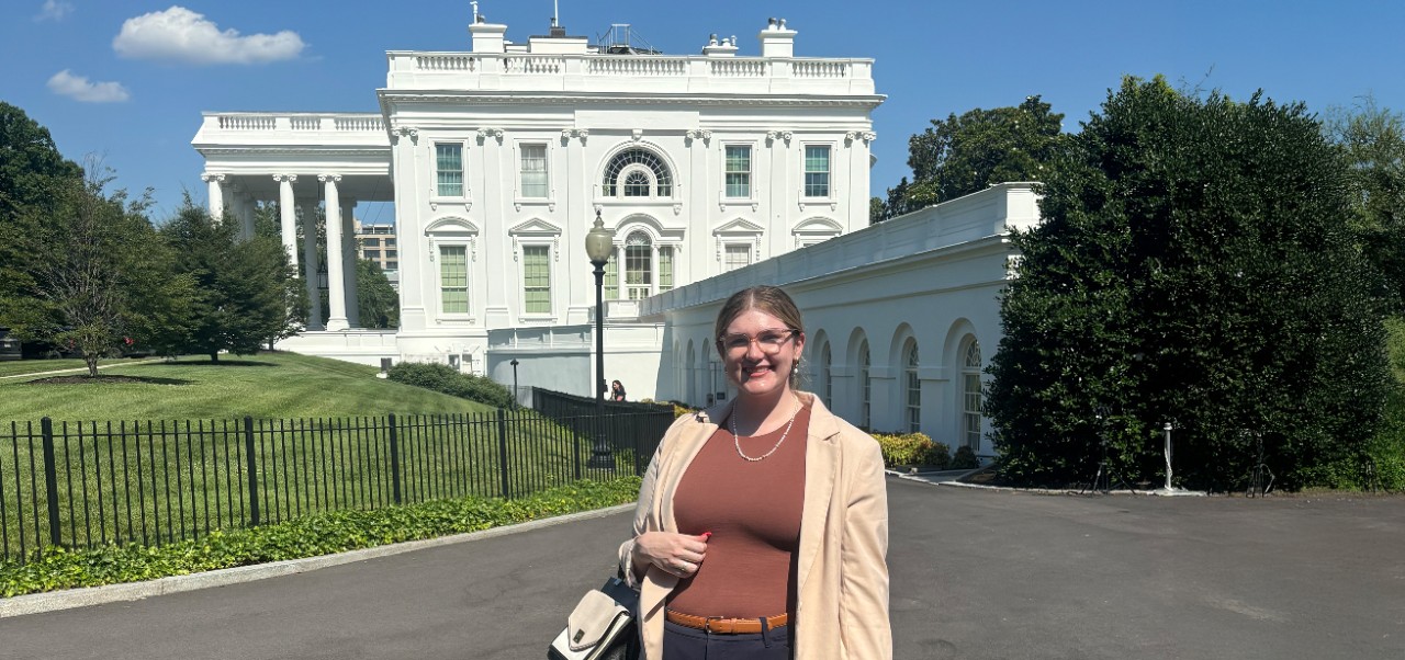 Hannah Josephson, Center for Publishing and Applied Liberal Arts at NYU SPS alumnus, smiles for the camera in front of a historic building.