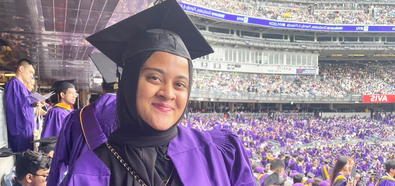 NYU SPS alumna Najla Reza wears a cap and gown at her graduation ceremony.