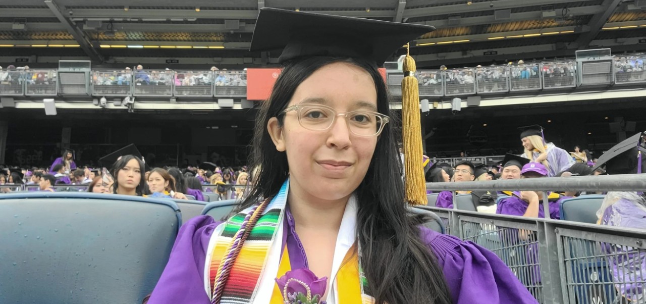 Samantha O'Connell, Center for Publishing and Applied Liberal Arts at NYU SPS alumnus, prepares for graduation in her purple cap and gown.