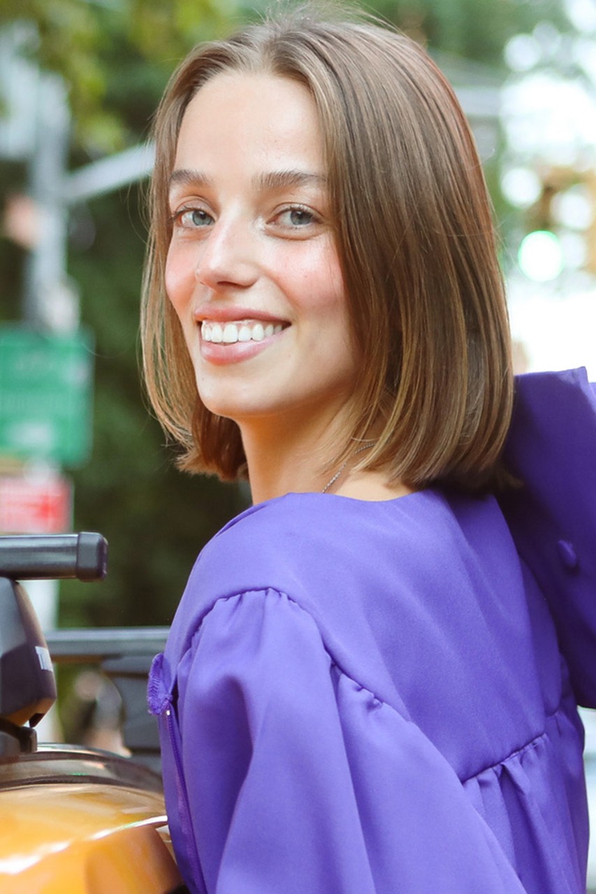 Jonathan Tisch Center of Hospitality alumnus Yasmine Barbes smiles for the camera while wearing graduation regalia.