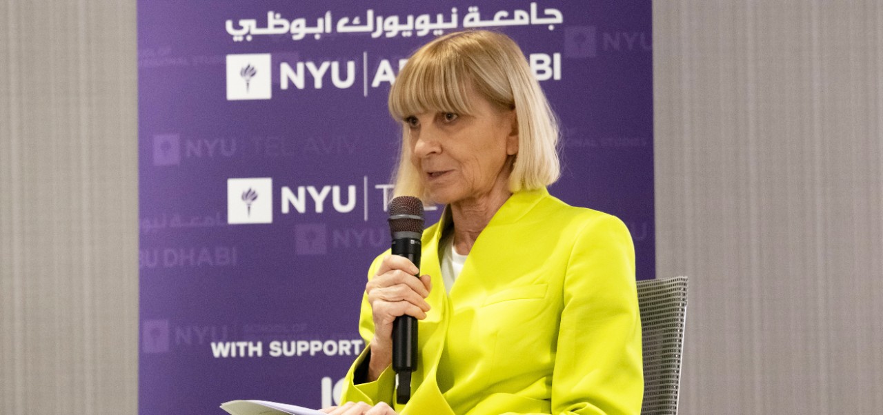 At the Future Workforce Global Summit in Berlin, Anna Tavis poses in front of a purple banner with four other women