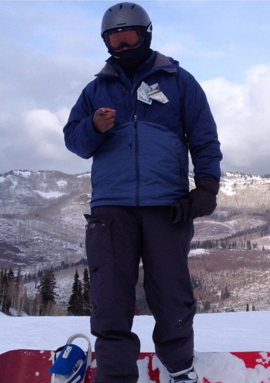 Brian C. Barker poses in front of a snowy mountain.