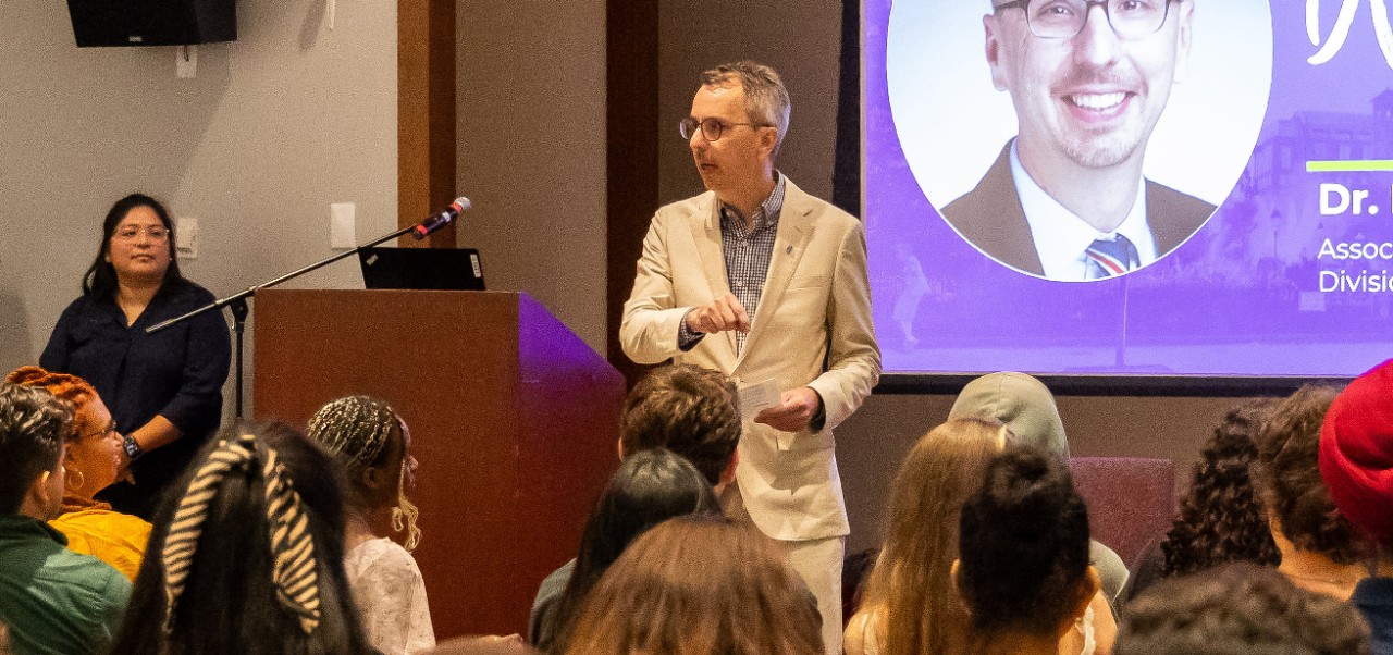 Douglas Harrison, Associate Dean, Division of Applied Undergraduate Studies at NYU SPS, provides a keynote presentation at a lectern in front of an audience.