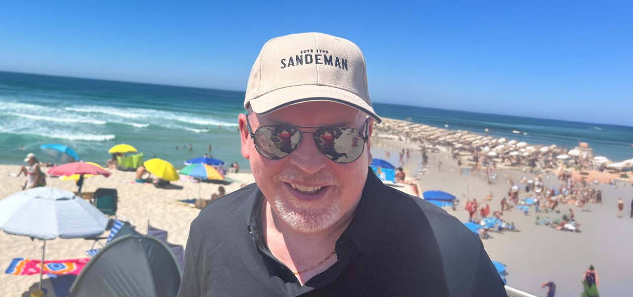 Kenneth A Kerrigan, Adjunct Instructor, Marketing and Public Relations, Division of Programs in Business, NYU SPS, smiles for the camera on a sunny day at the beach.