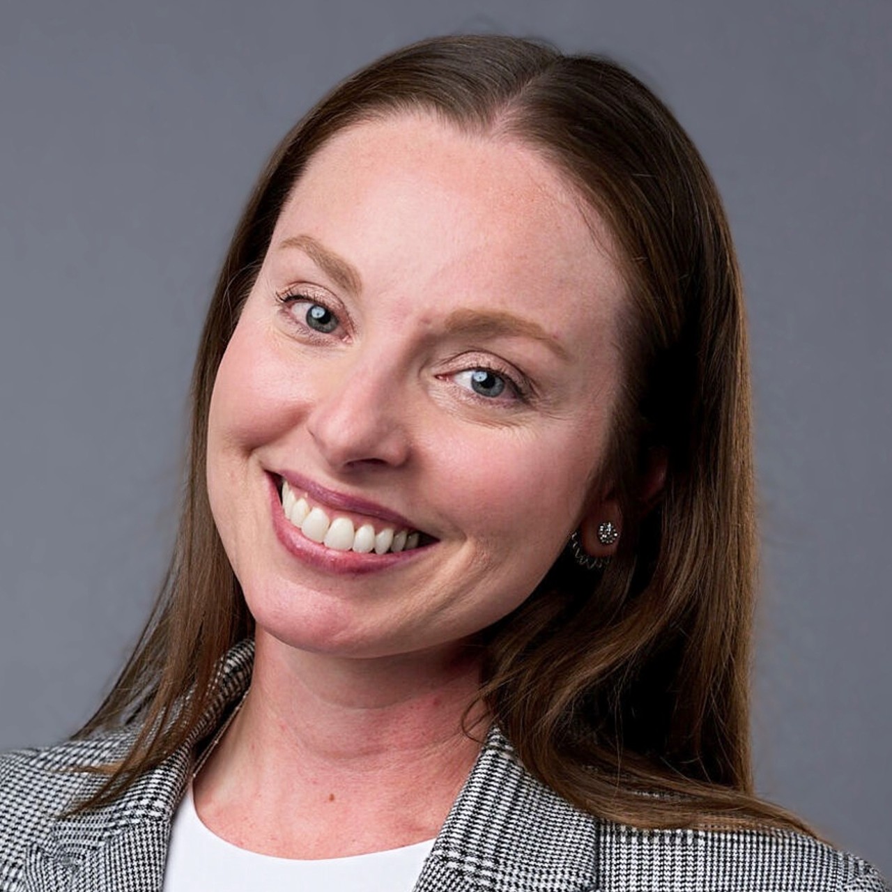 Smiling headshot of Sabrina Corrozza in a blazer