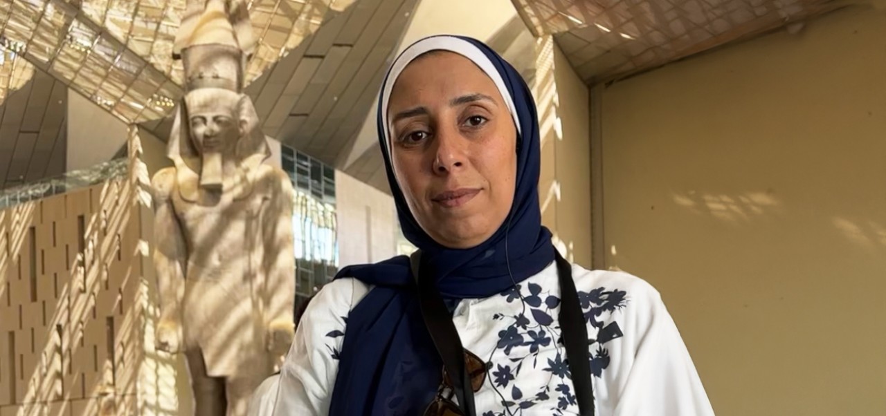 Yasmin Alkashef. Adjunct Instructor, Center for Publishing, Writing, and Media, poses for a photo near an exhibit of Egyptian antiquities at the Metropolitan Museum of Art in New York City.