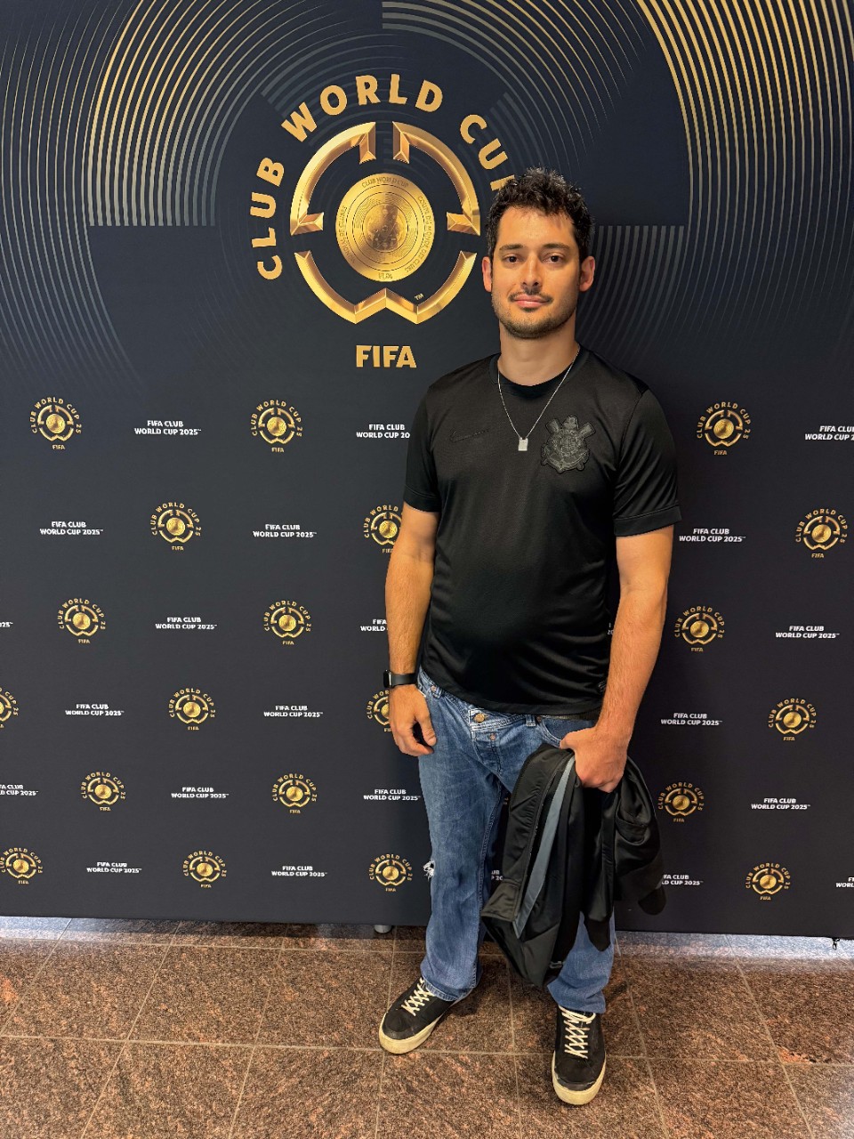 Gustavo Giusti stands in front of a Club World Cup sign.