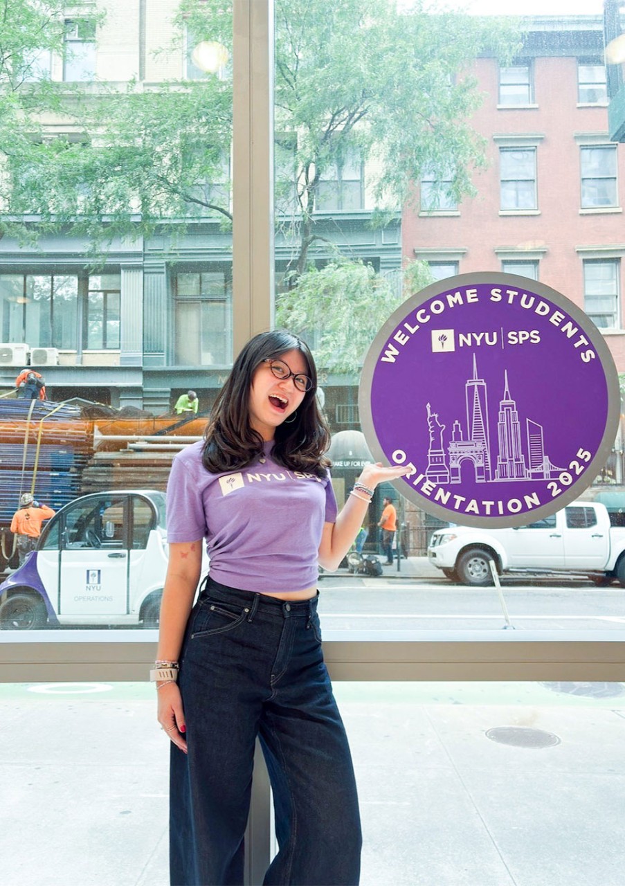 Natasya Maurren Tan poses in front of an NYU SPS logo.