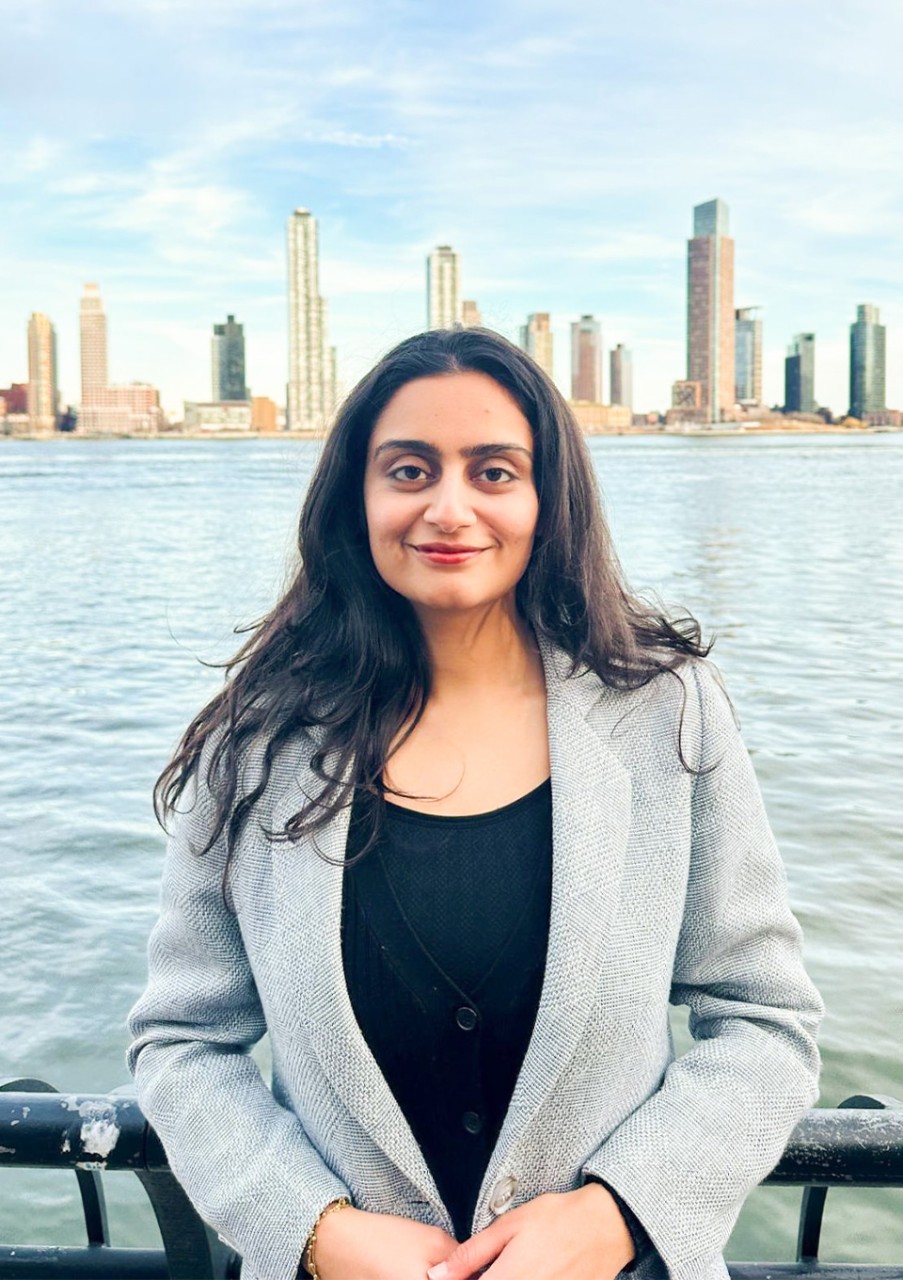 Sejal Tandon wears a blazer with the New York City skyline in the background.