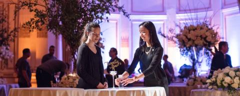 nyu students setting up a table at an event