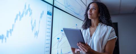 professional looking at stats on a graph