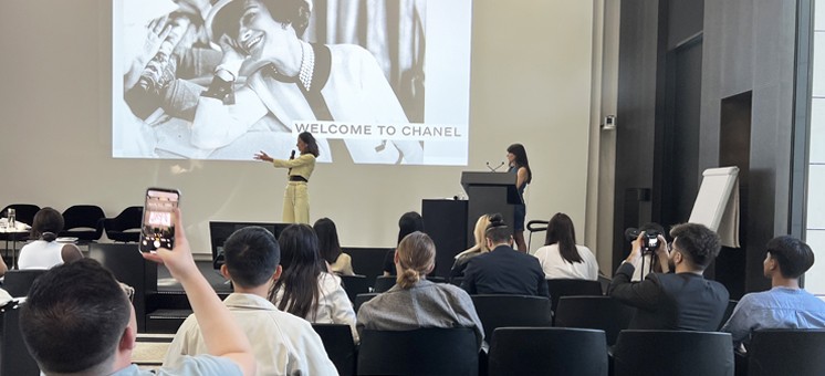 Speaker shares a black and white photo of Coco Chanel on stage at a Global Field Intensive for the MS in Integrated Marketing program at the Cannes festival in Paris