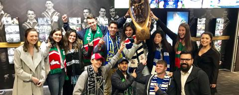 nyu students holding a trophy