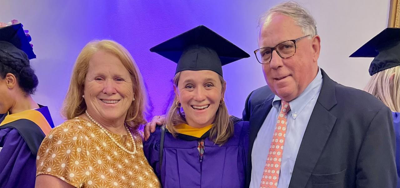 Caroline Kasper, NYU SPS Preston Robert Tisch Institute for Global Sport alumnus, smiles for the camera with her parents at her graduation from NYU SPS.