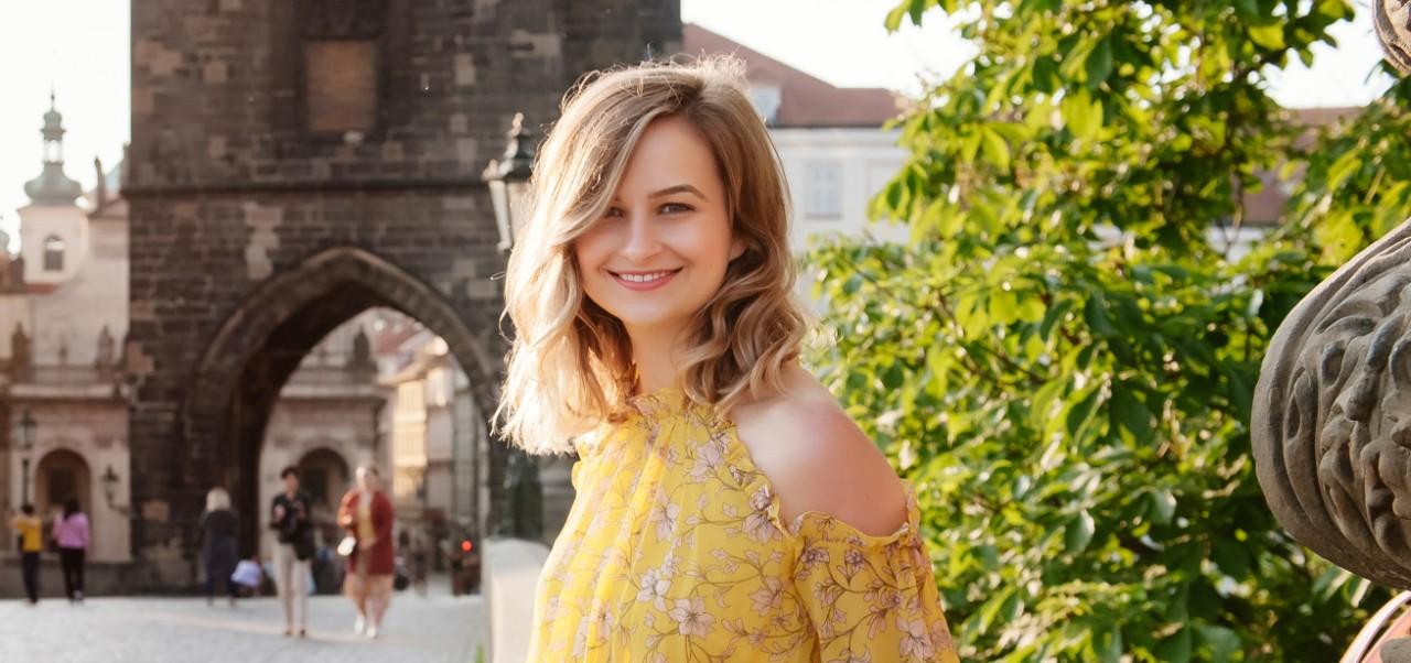 Roksolana Maria Sheverack, NYU SPS Division of Programs in Business alumnus, poses for a picture on the Charles Bridge in Prague.