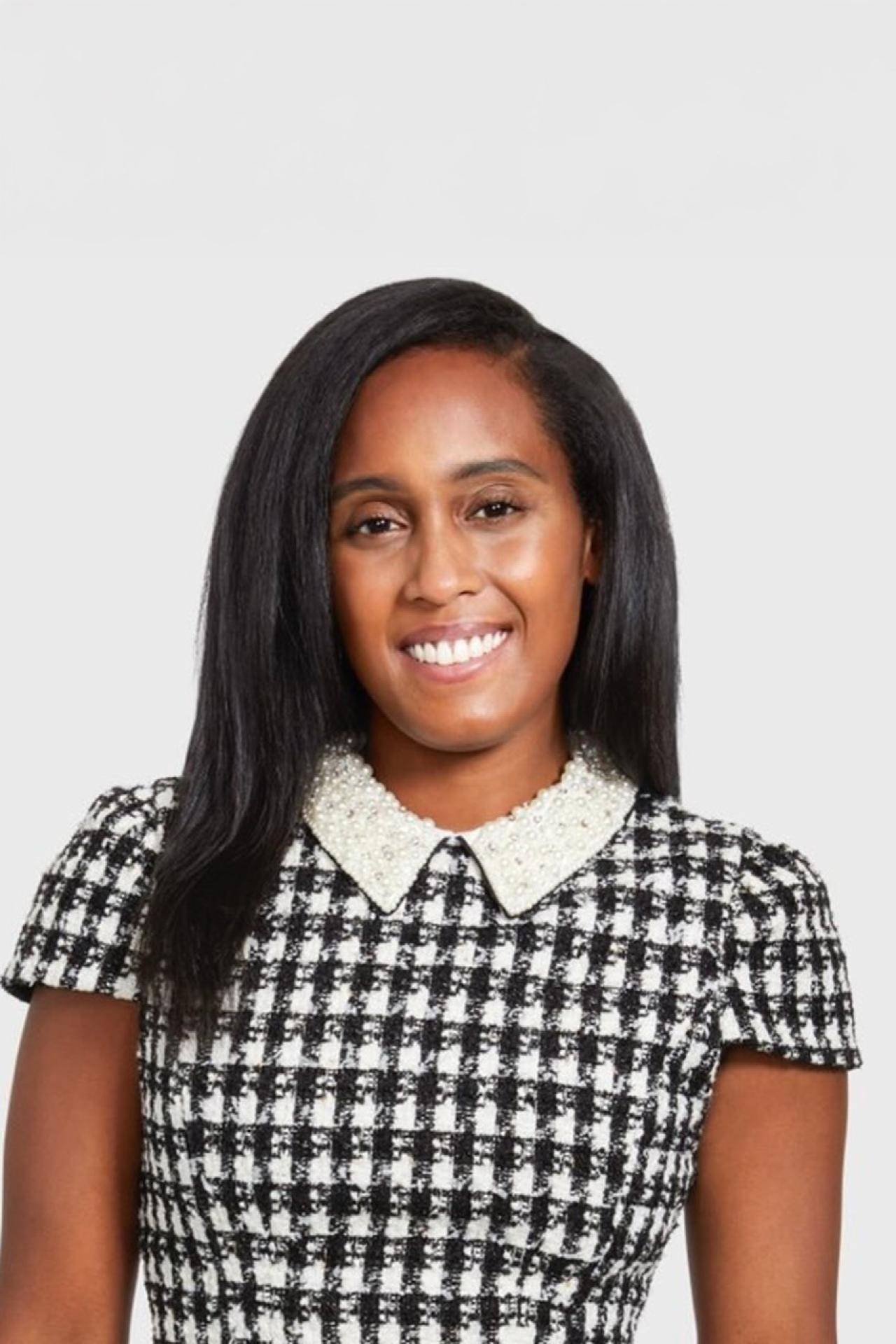 Symone Williams, NYU SPS Division of Programs in Business alumnus, poses for a photo at the ColorComm Conference.