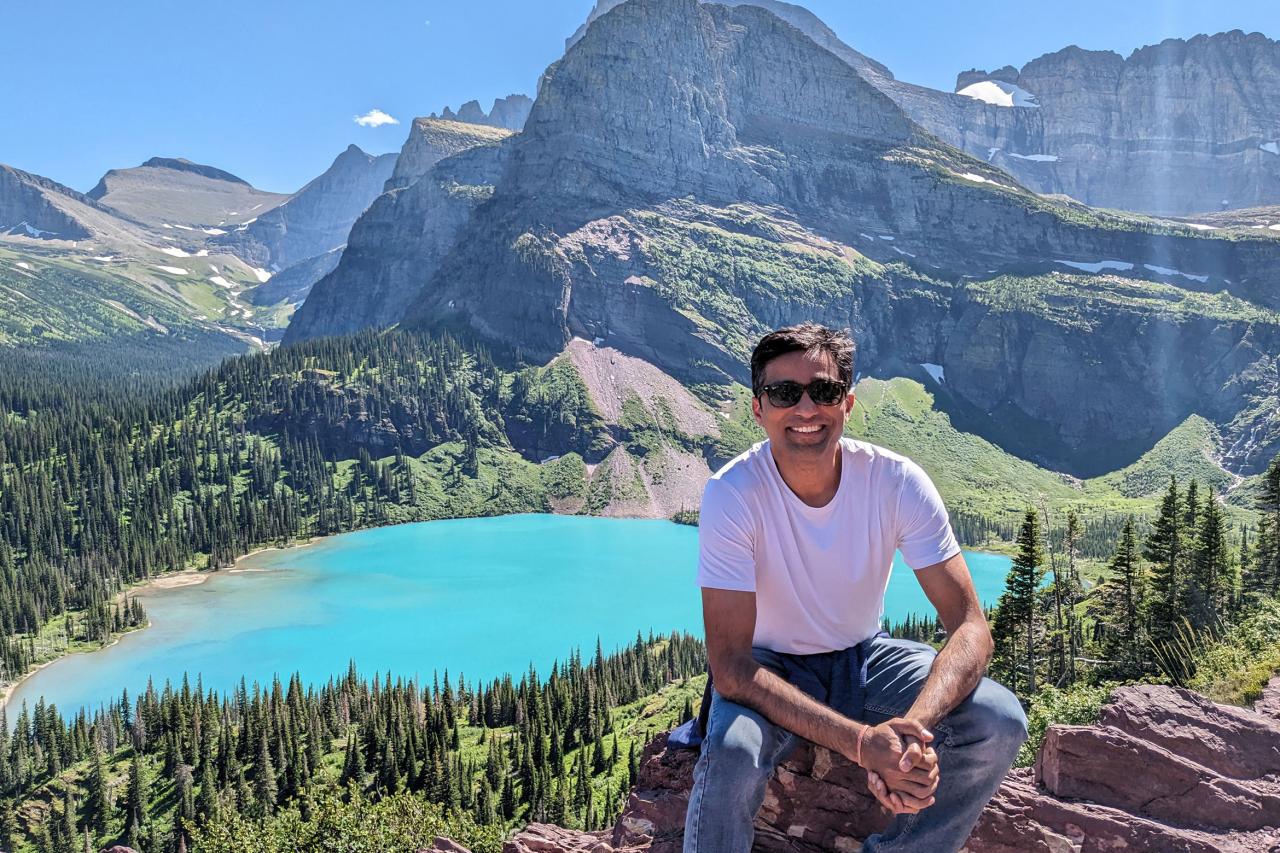 NYU SPS CE faculty member Amar Vajjhala snaps a selfie at USA National Park in front of a blue lake
