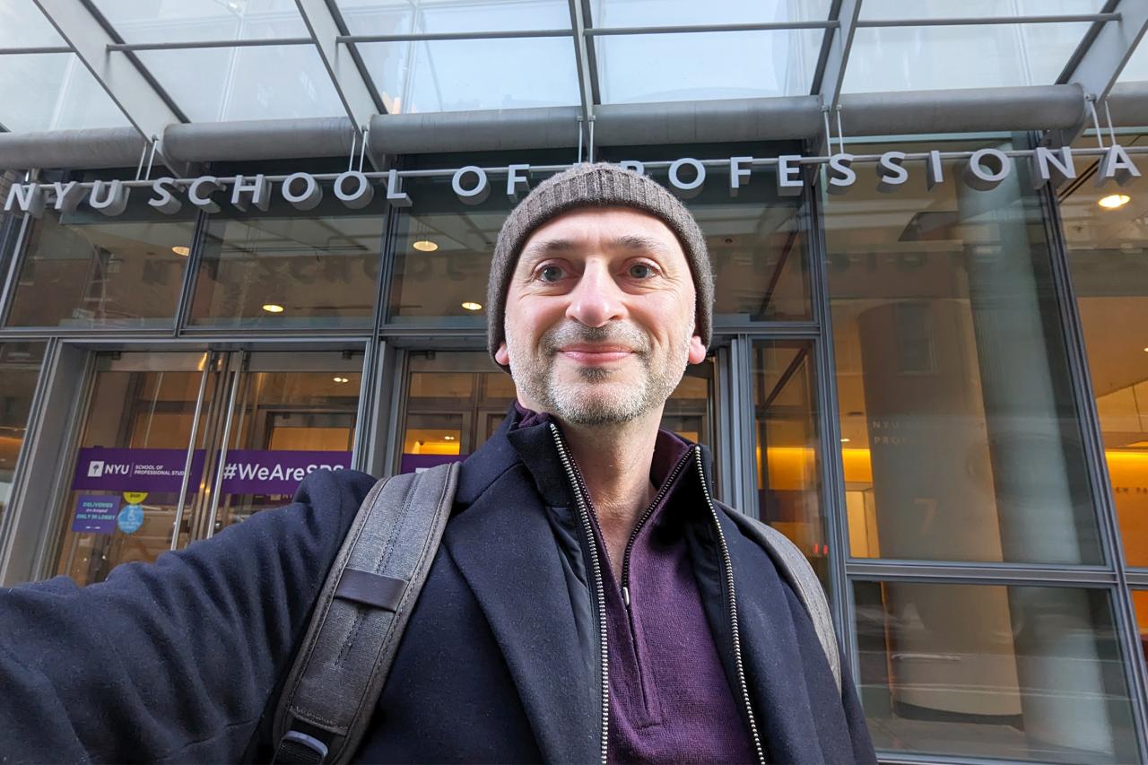 NYU SPS Continuing Education instructor Boris Keivsky snaps a selfie outside of an NYU School of Professional Studies academic building