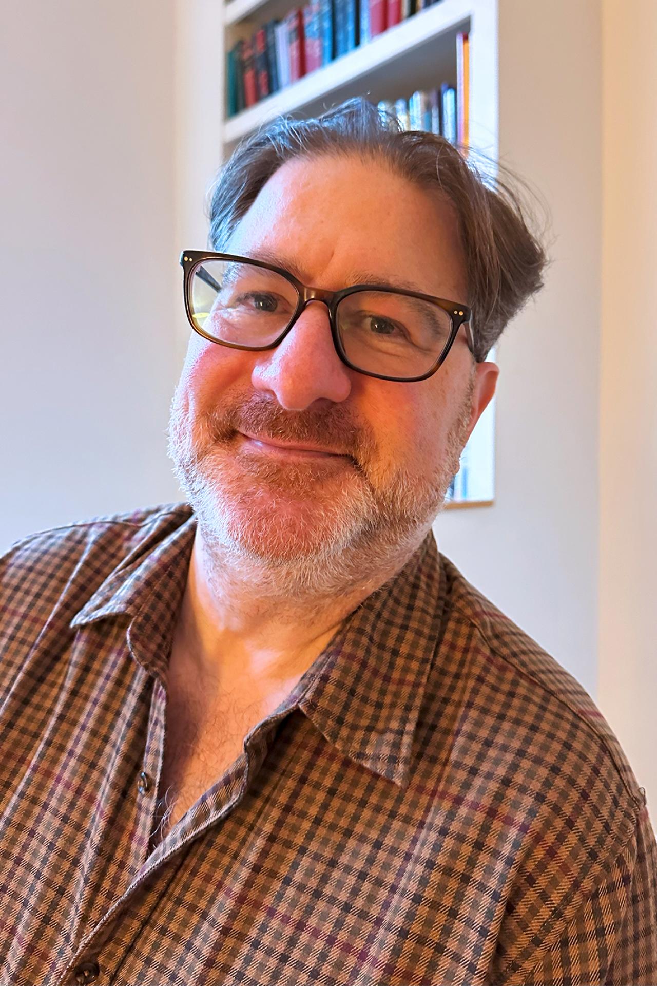 NYU SPS Continuing Education instructor James Berman holds a coffee cup in a restaurant