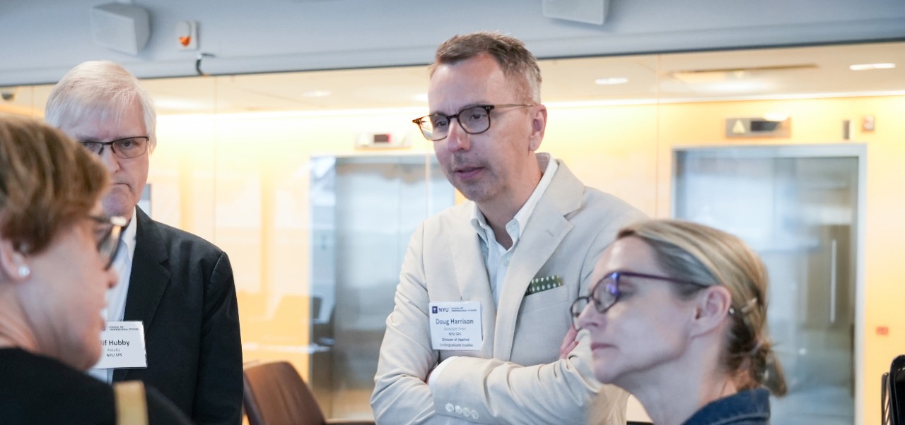 Douglas Harrison, Associate Dean, Division of Applied Undergraduate Studies at NYU SPS, provides a keynote presentation at a lectern in front of an audience.