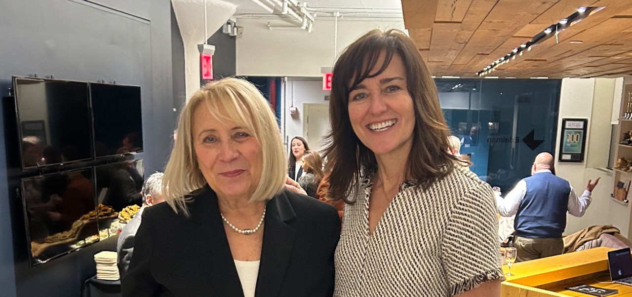 Kathleen Rennie, Clinical Assistant Professor of Marketing and Public Relations, Division of Programs in Business at NYU SPS, poses for a photo with a colleague.