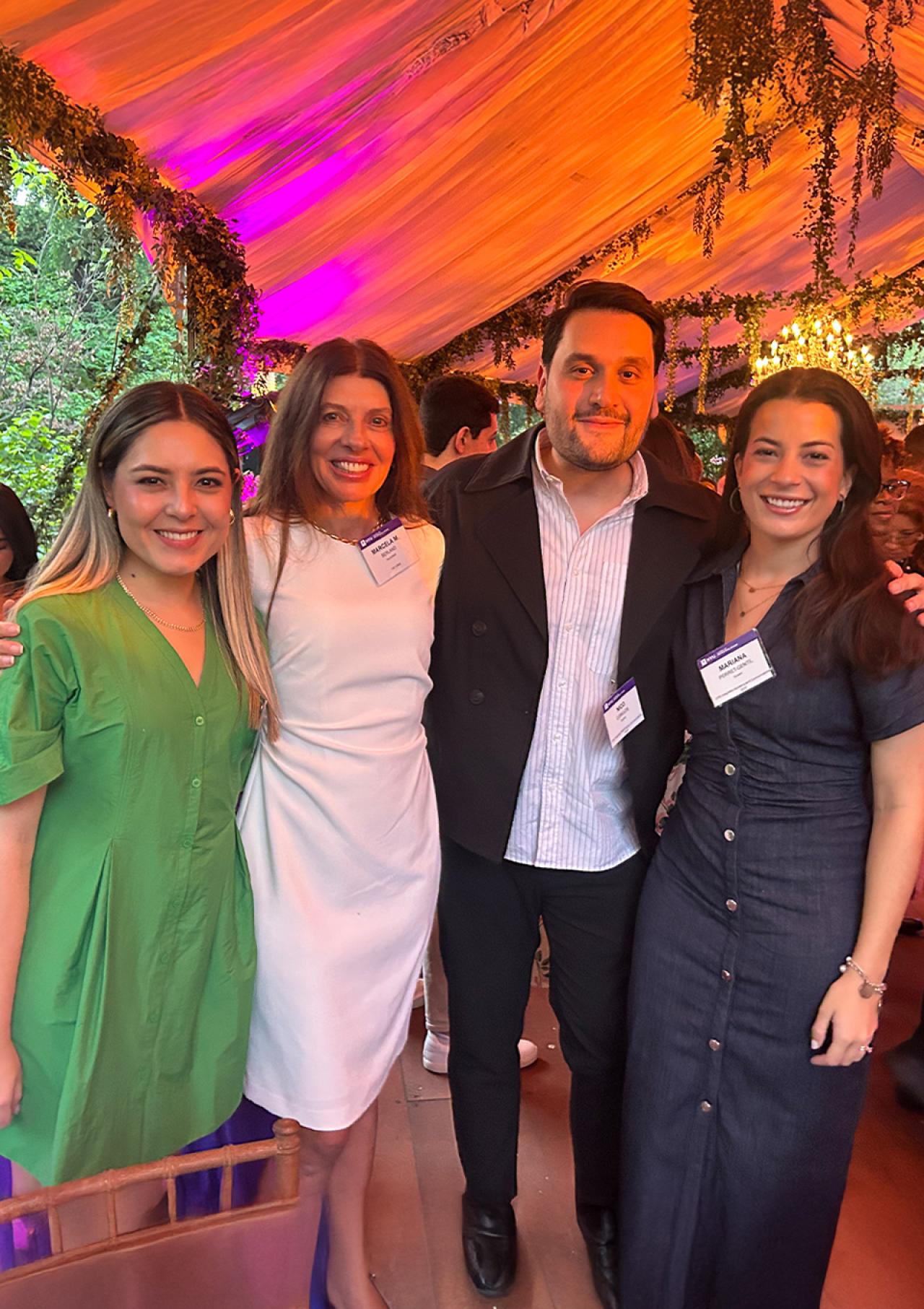 Marcela Berland poses for a photo with fellow NYU SPS faculty and students.