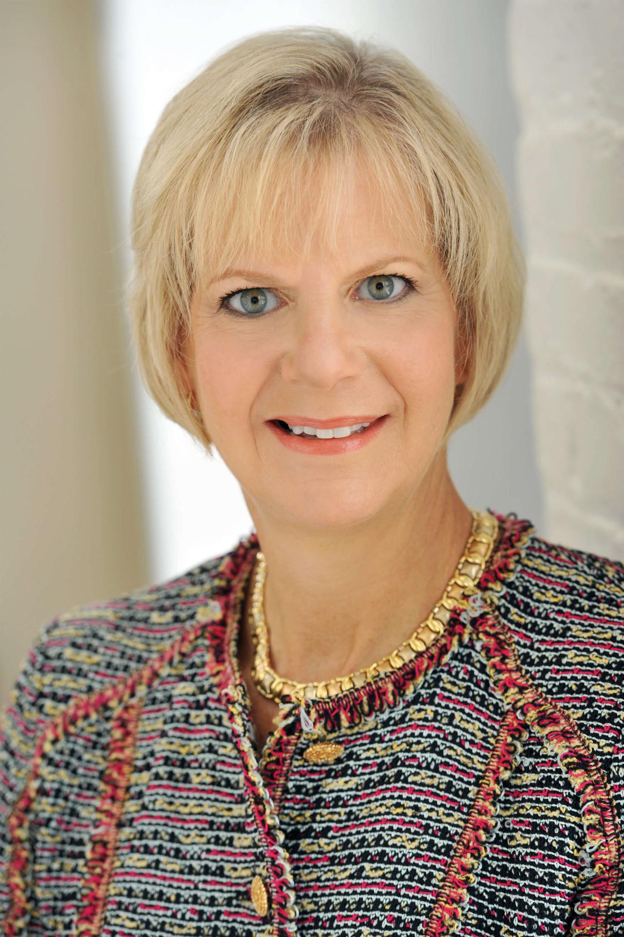 Headshot of Merrie Frankel smiling in a knit jacket.
