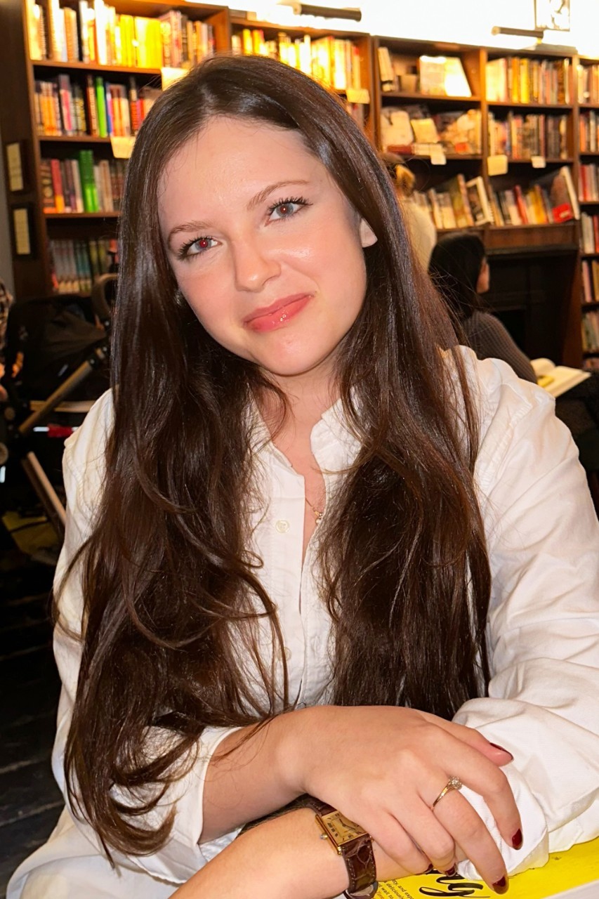 Brooke Houghton, student at the Center for Publishing and Applied Liberal Arts at NYU SPS, poses for a photo at a bookstore.