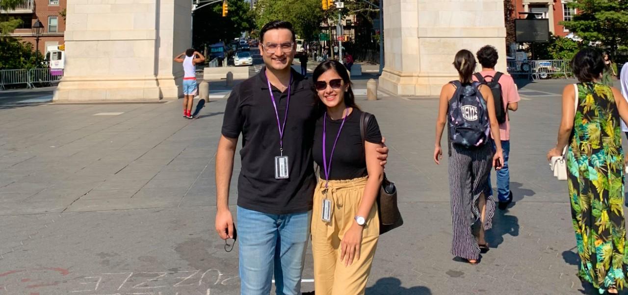 NYU SPS student Chaithanya Bhathi poses for a photo in front of an arch with her husband in Washington Square Park