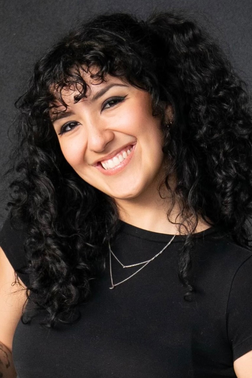 NYU SPS student Tori Cignarella smiles for a headshot in front of a neutral background.