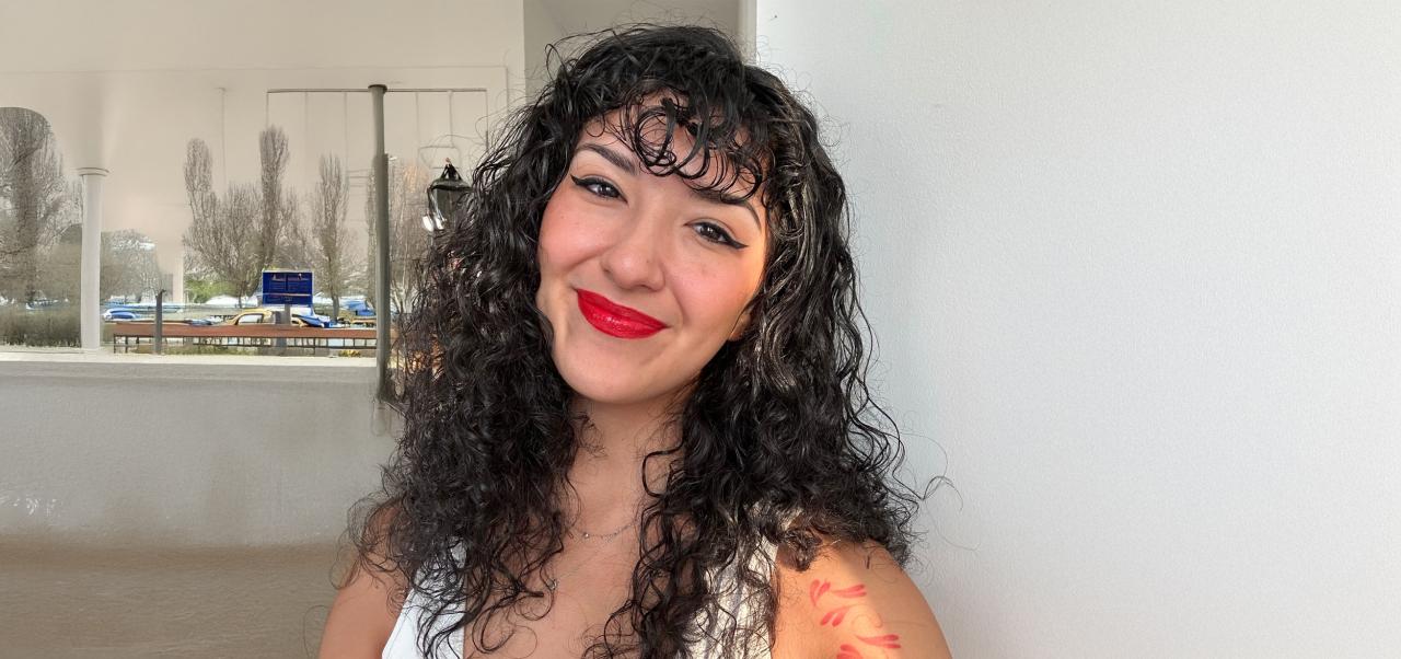 NYU SPS student Tori Cignarella smiles for a headshot in front of a neutral background.